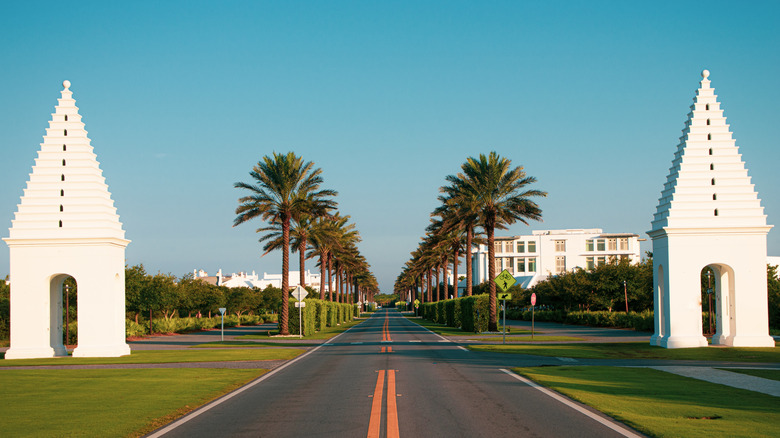 Alys Beach entrance with Greek-style minaret and lined palm trees in Florida