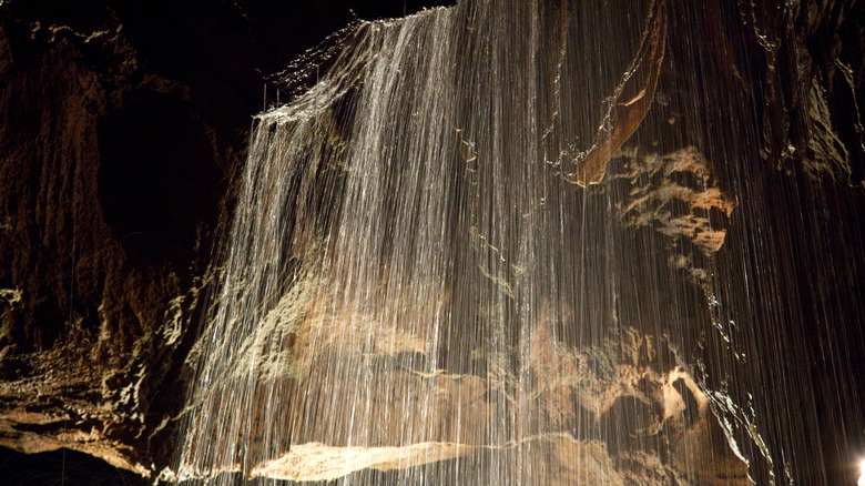 Cave waterfall cascades over rocks