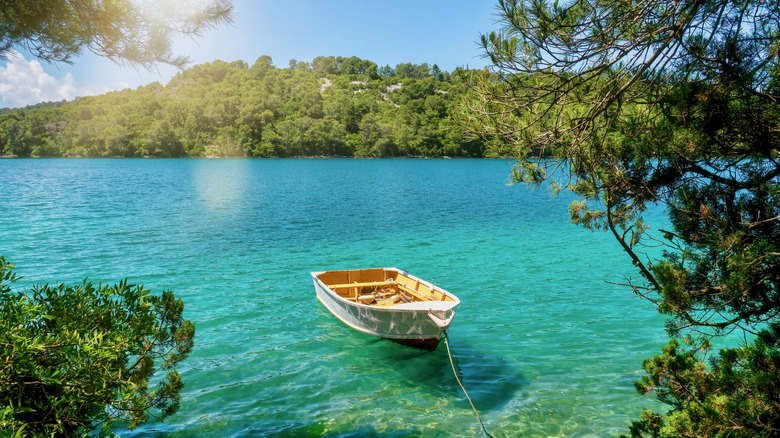 A rowboat tied to the shore of Veliko Jezero, in Mljet National Park, Mljet Island, Croatia