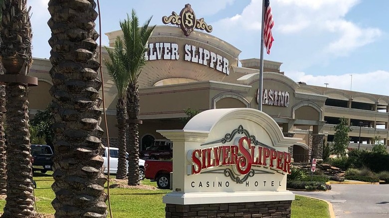 Exterior of Silver Slipper Casino building with palm trees.