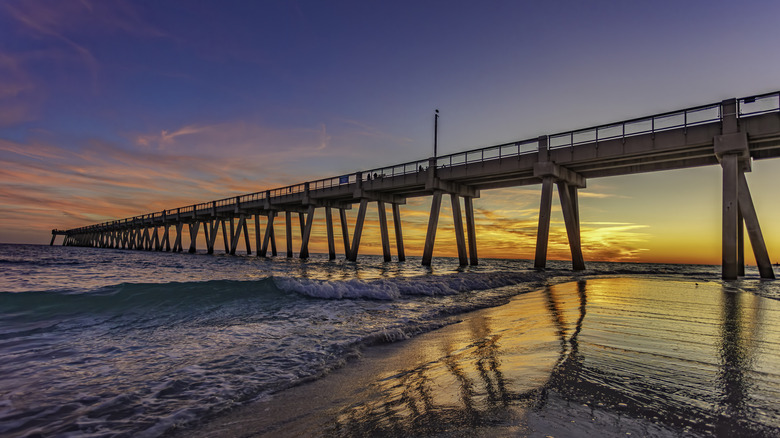 Navarre Beach Pier concrete piles and waves at the beach
