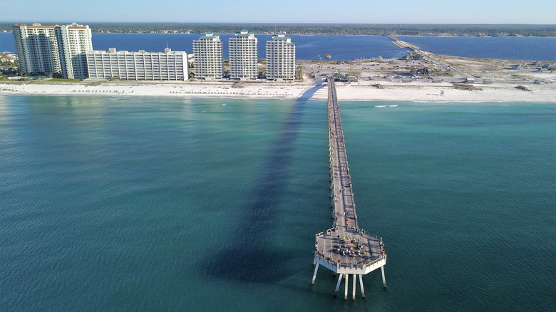 Navarre Beach Pier sticking out on the turquoise water at the beach