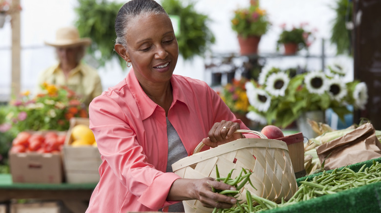 A woman shopping for produce at a farmers market