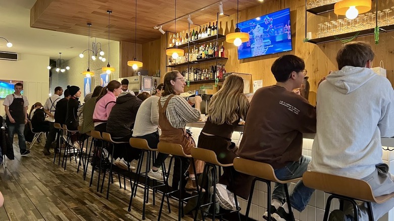 People eating at the bar inside I Egg You