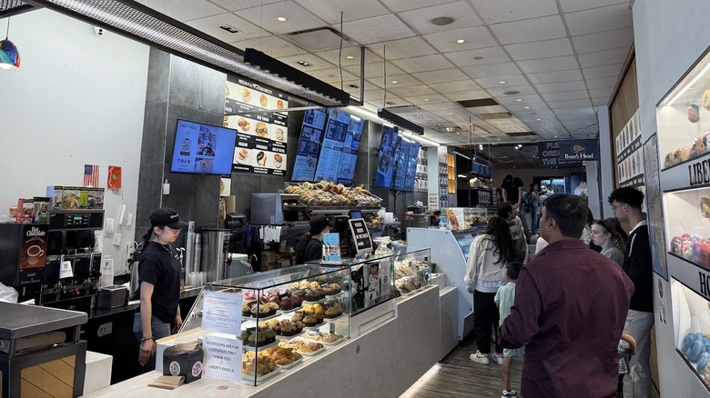People standing at counter at Liberty Bagels