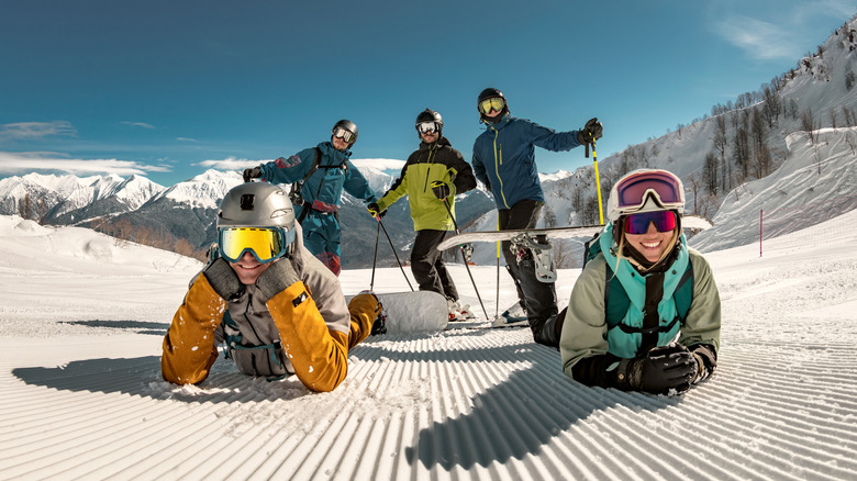 A group of happy skiers and boarders having fun