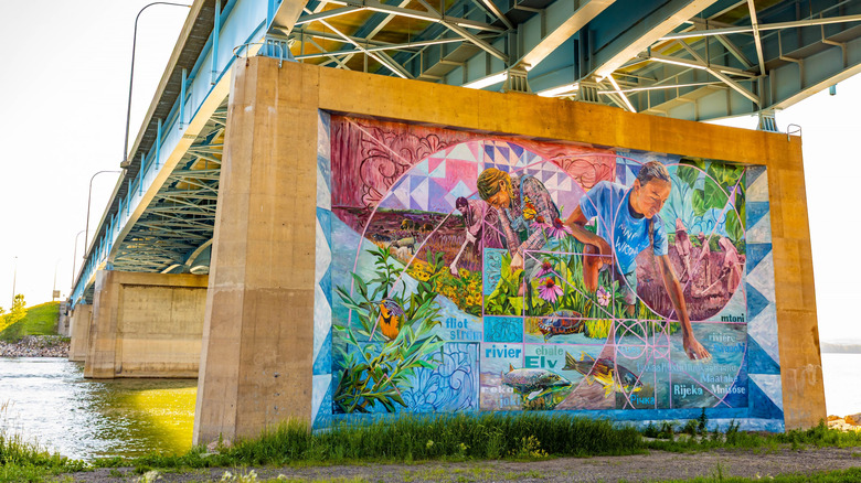 A vibrant community-painted mural, Missouri River Heritage located beneath the I-94 bridge in Bismarck.