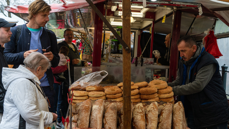 People buying fresh bread at food market in Berlin
