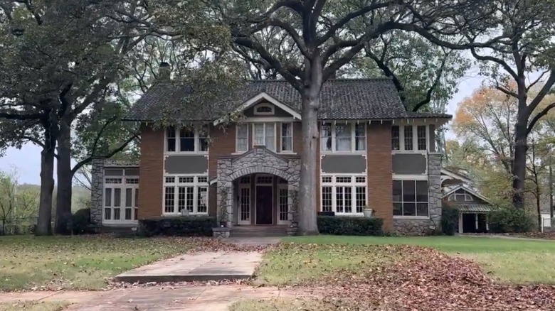 Historic house gray shingles with white trim and brick walls