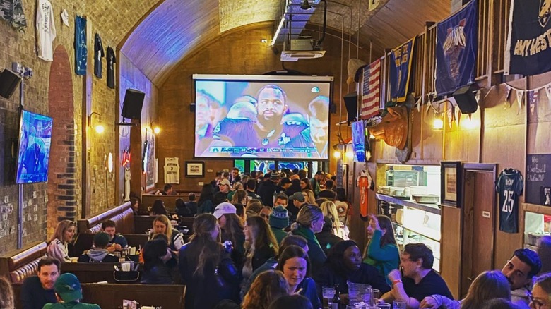 Busy interior of Passyunk Avenue in London decorated with sports memorabilia