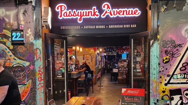 Entrance to Passyunk Avenue in London framed by graffitied walls