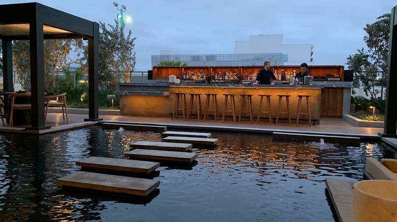 A bar behind a reflecting pool at MILA in Miami.