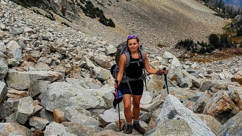 A hiker on her way up to Legore Lake through a boulder field