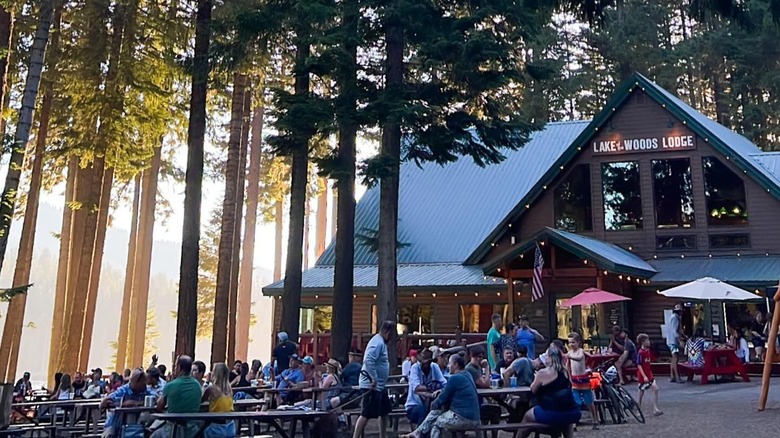 Exterior of Lake of the Woods Lodge with people at picnic tables.