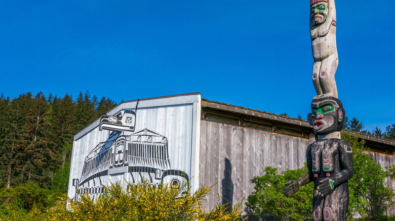 The exterior of U'Mista Cultural Centre and a totem pole in Alert Bay, British Columbia