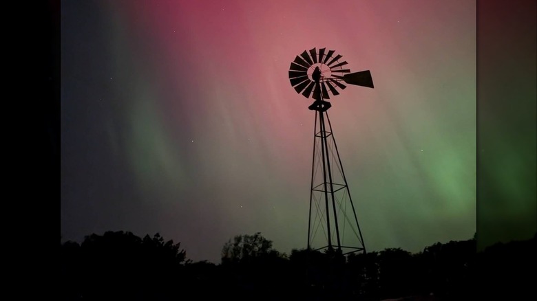 Northern lights behind a small windmill