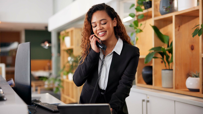 A hotel concierge on the phone