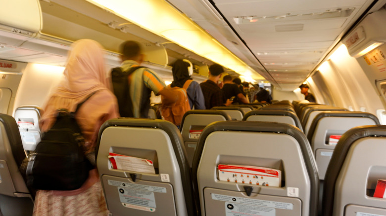 Passengers lining up to get off a plane