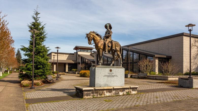 Bronze statue of a man riding a horse displayed in Keizer, Oregon