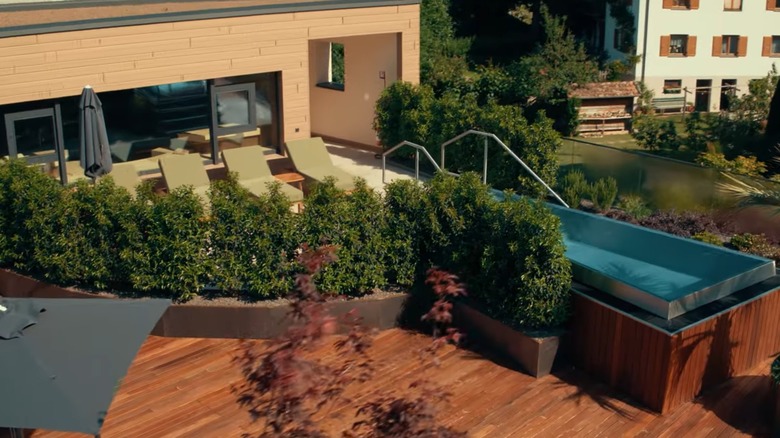 A room with a private deck and pool at Quellenhof See Lodge in Merano, Italy