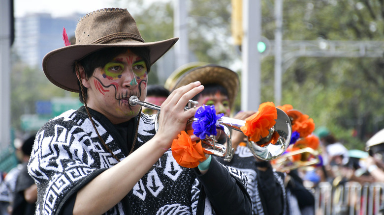Musician playing during Dia de Los Muertos parade