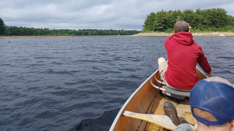 Two men paddling a canoe across Lake Rossignol in Queens County, Nova Scotia, Canada