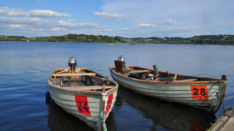 Two boats docked on the shore of Chew Valley Lake