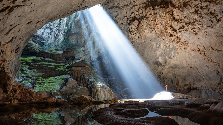 Sunbeams fill the passage with light in Son Doong Cave