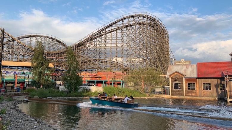 A view of Le Monstre rollercoaster from across the water of a log flume ride