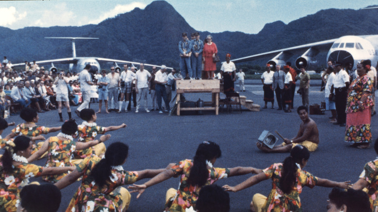 Traditional dancers perform for Apollo 13 astronauts at air field