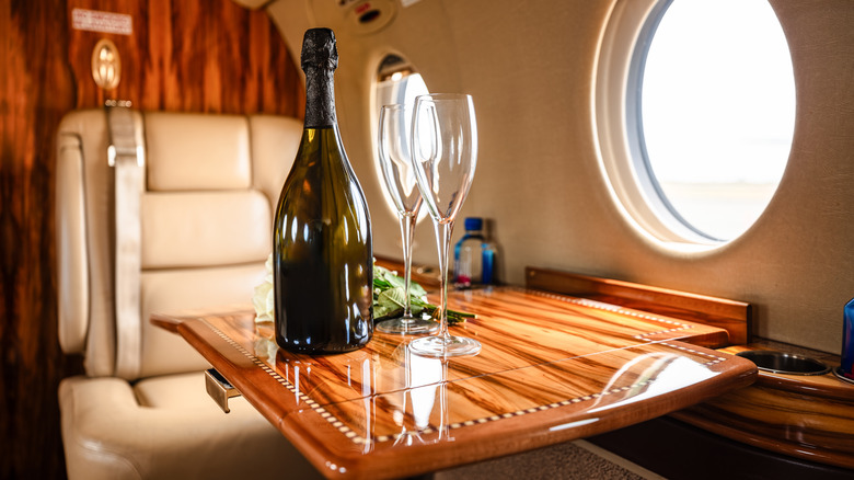 Champagne bottle on a table in a private jet