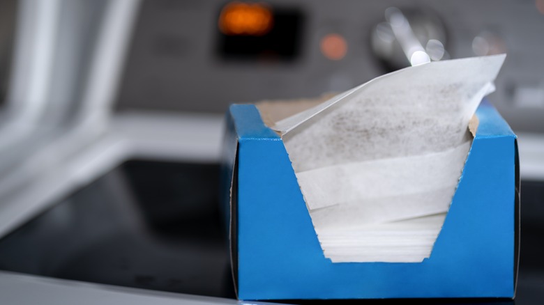 Box of dryer sheets on washer