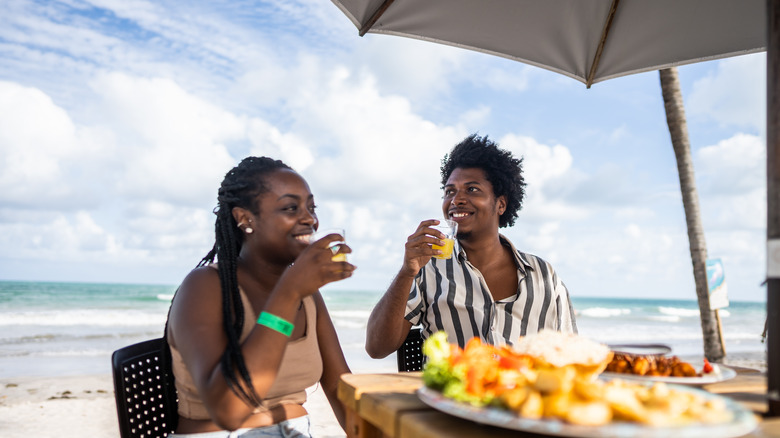 Couple having lunch on the beach