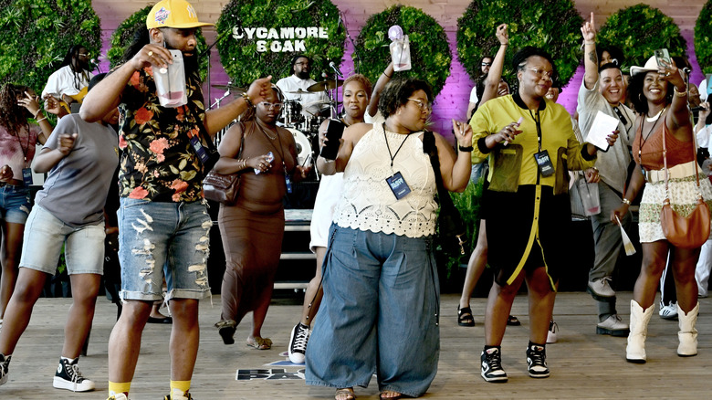 People line dancing in a festive environment