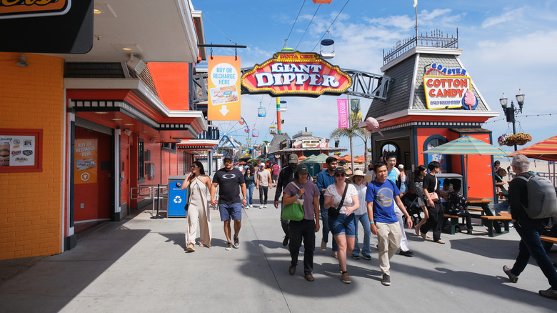 People walking along Santa Cruz Boardwalk