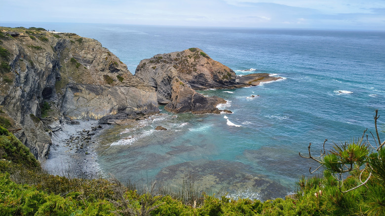 Cliffs towering above turquoise waters of the Atlantic along the Fishermen's trail