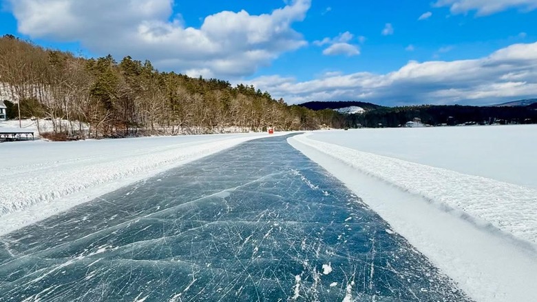 The Lake Morey Ice Skating Trail on a sunny day, surrounded by snow