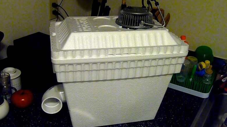 DIY air conditioner made out of a styrofoam cooler, a fan, and PVC pipe