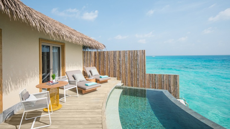 Pool and pool deck at an overwater villa at the InterContinental Maldives Maamunagau Resort