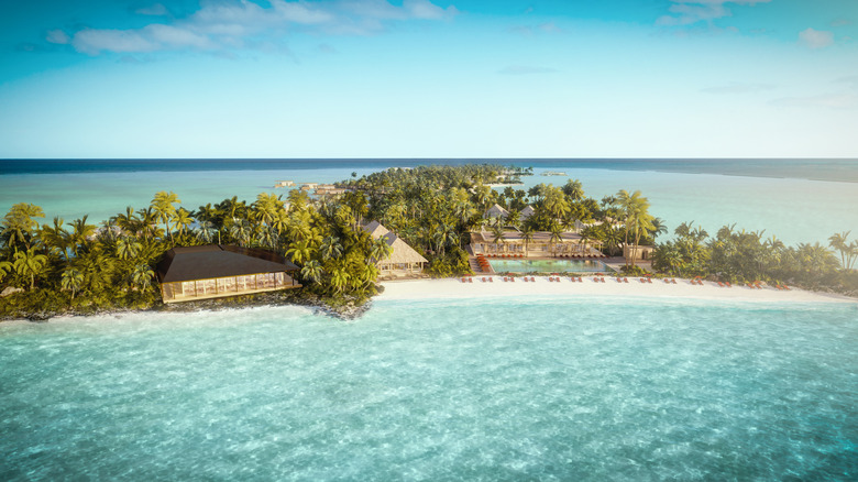 An aerial view of the Bvlgari Hotel, with sun-drenched beaches and palm trees, in the Maldives