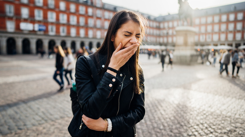 Woman yawning while traveling