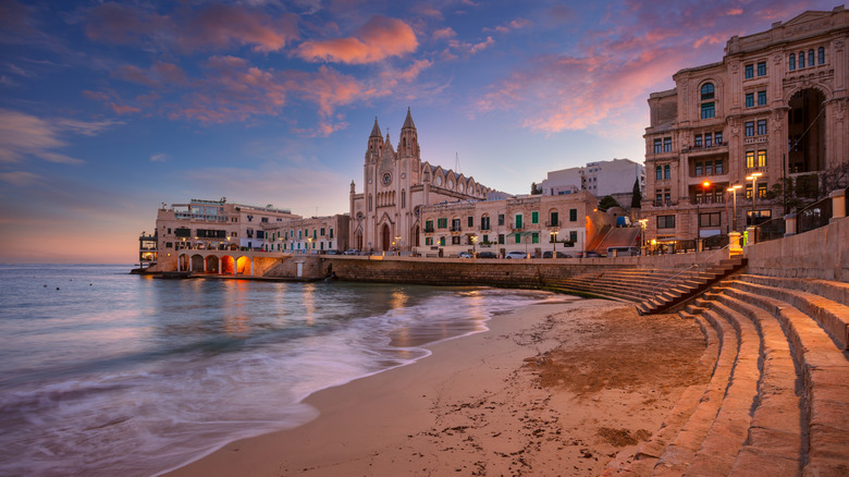 Buildings overlooking Malta beach at sunrise