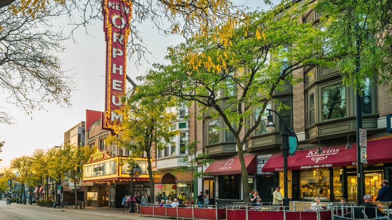 People sit at cafe-bar patios on State Street near the Orpheum Theater in Madison, Wisconsin