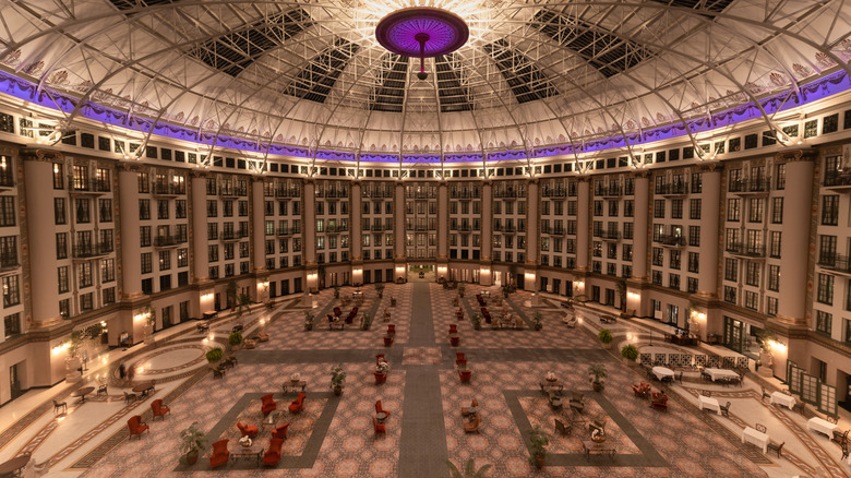 the expansive atrium of Indiana's West Baden Springs Hotel, lit up in the evening with white and purple lights