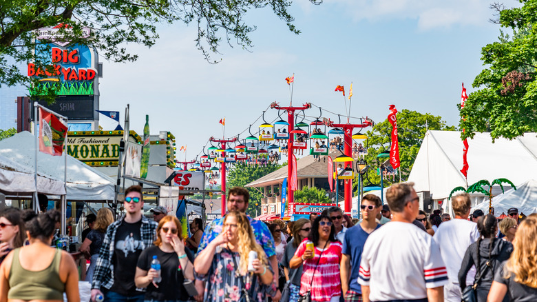 Summerfest, with vendor tents and a skylift in the background and a dense crowd in the foreground