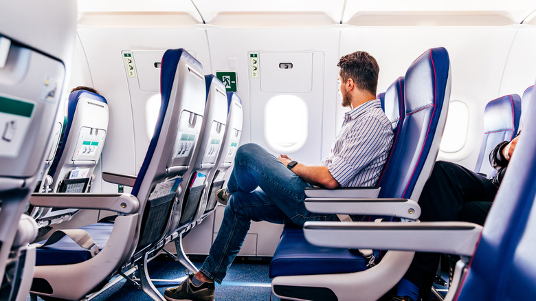 A man sitting cross legged on a flight