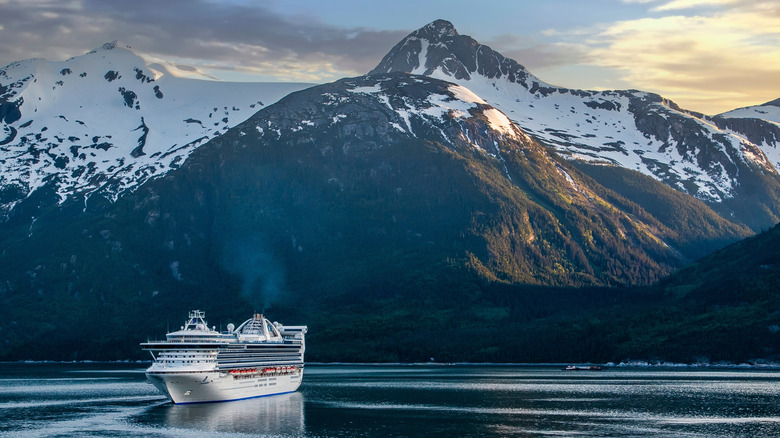 Cruise ship in front of a snowy Alaska mountain range
