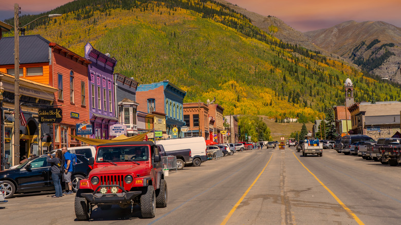 Colorful Old West buildings in Silverton, CO, near autumn-hued mountains