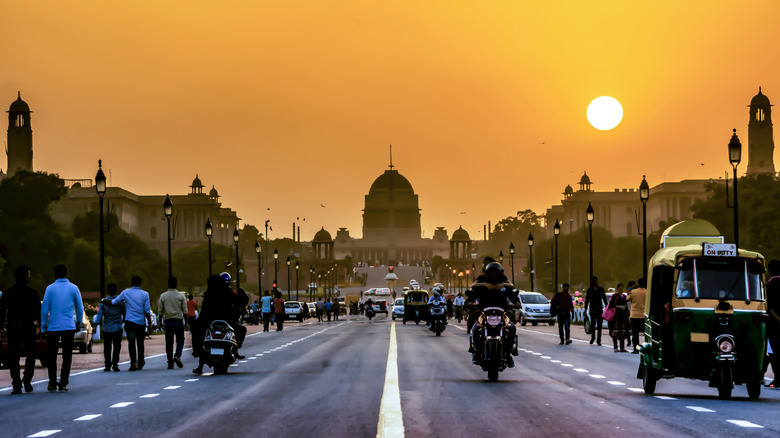 Bustling city scene in Delhi, India at sunset
