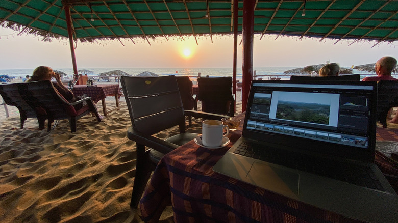 Laptop set up on a beachside cafe in Goa, India